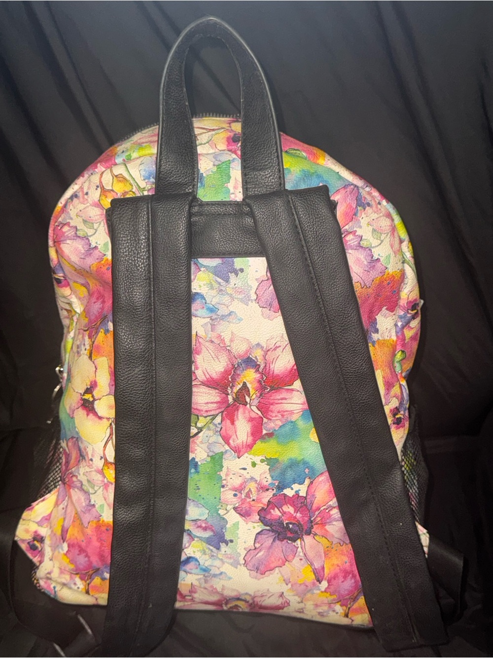 This is a Betsey Johnson watercolor floral vinyl backpack